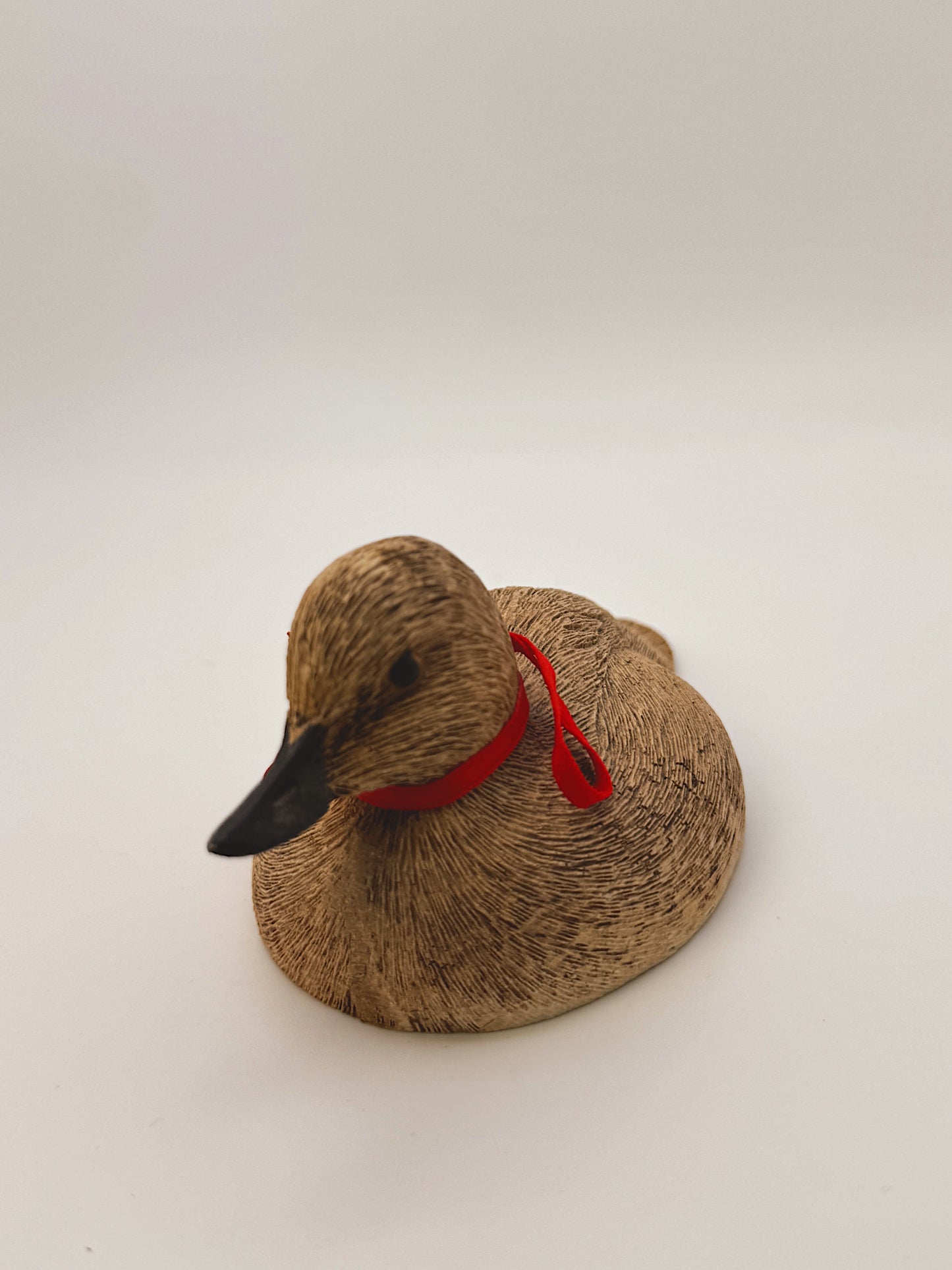 Vintage Wooden Duck Figurine with Red Ribbon Collar